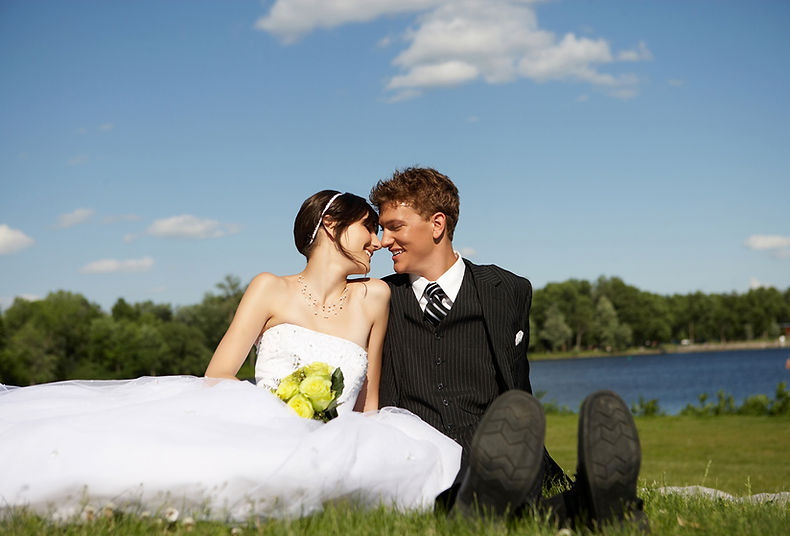 bride and groom smiling on golf course
